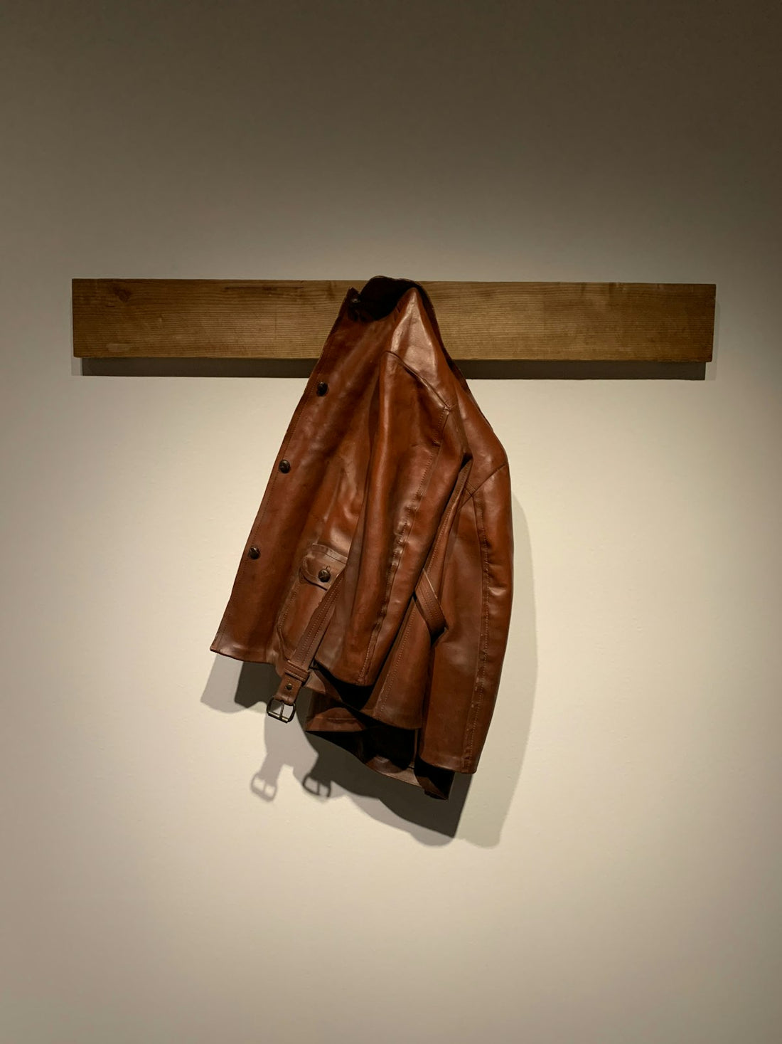 Brown leather jacket on hook