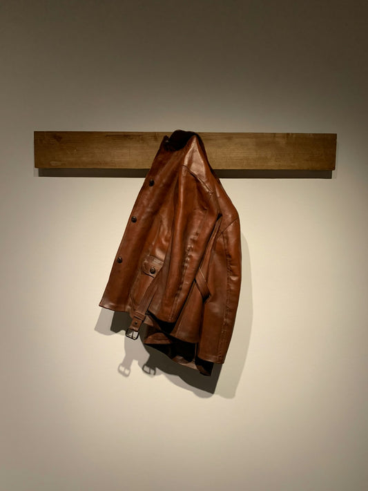 Brown leather jacket on hook